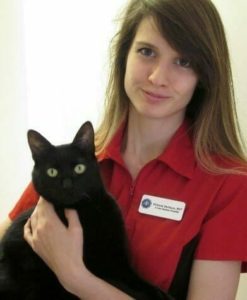 Victoria the vet tech holding a black cat